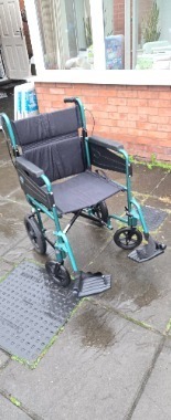 Attendant-propelled lightweight wheelchair in excellent working condition